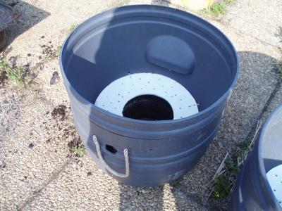 A self-watering grower built out of a used barrel & a growing basket